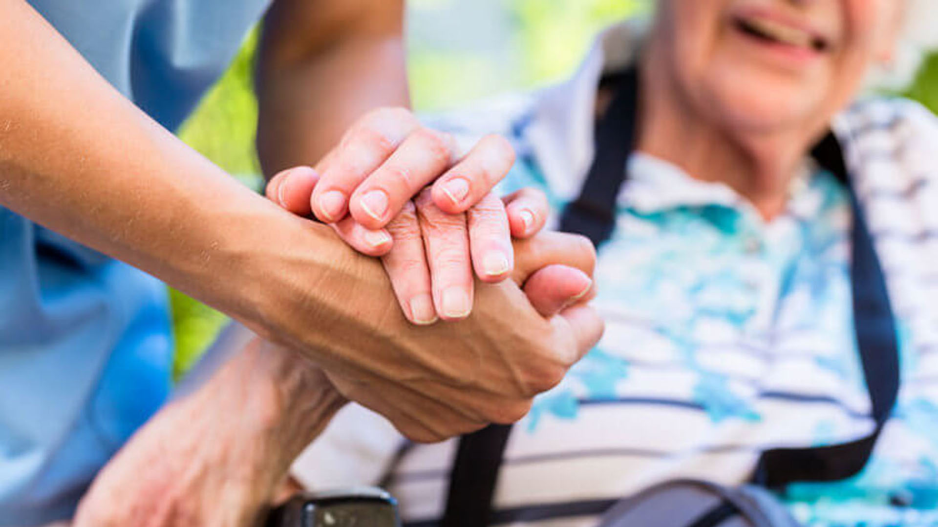 Caregiver holding elder person's hand - links to 2026 Alzheimer’s Disease Initiative Request for Proposal (RFP)