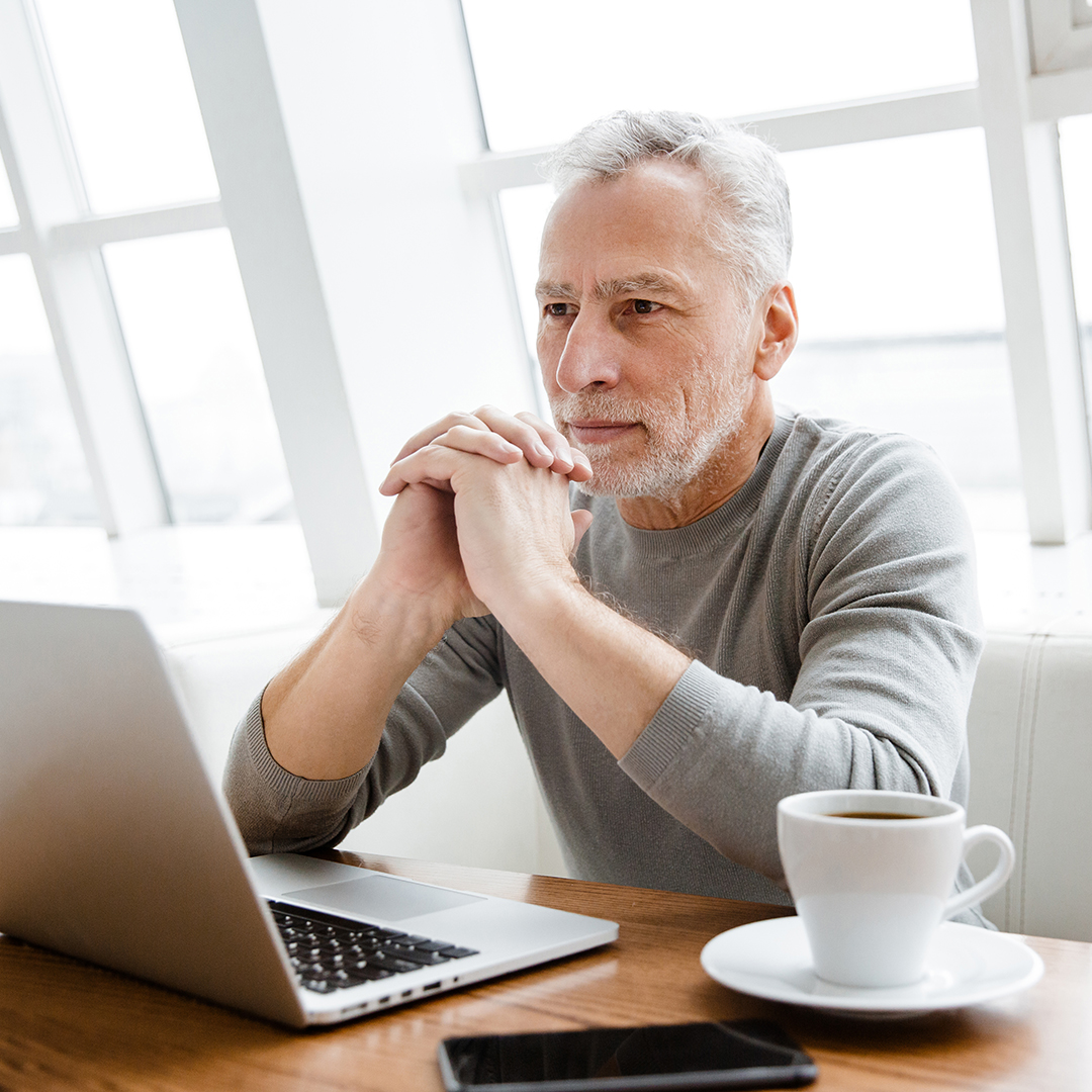 senior man looking at his laptop