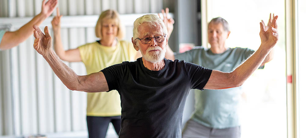 Group of elderly senior people practicing Tai chi class in age c